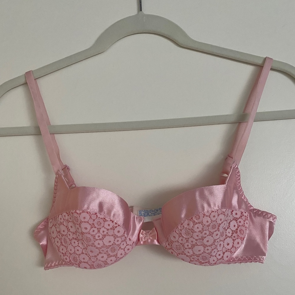 Vintage pink lace bra with satin trim.